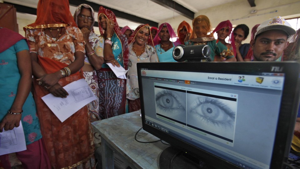 Women stand in a line to enroll in the Unique Identification (UID) database system at Merta district in the desert Indian state of Rajasthan February 22, 2013. 