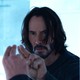 Keanu Reeves points two fingers at his reflection in a mirror in "The Matrix Resurrections."