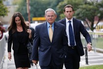 New Jersey Senator Bob Menendez pictured with two other people