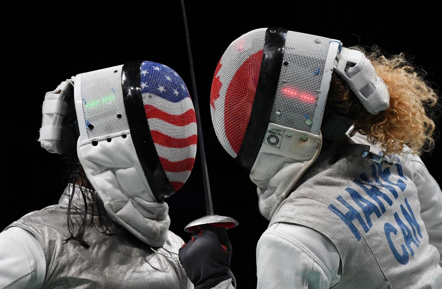 Two fencers face off, close together.