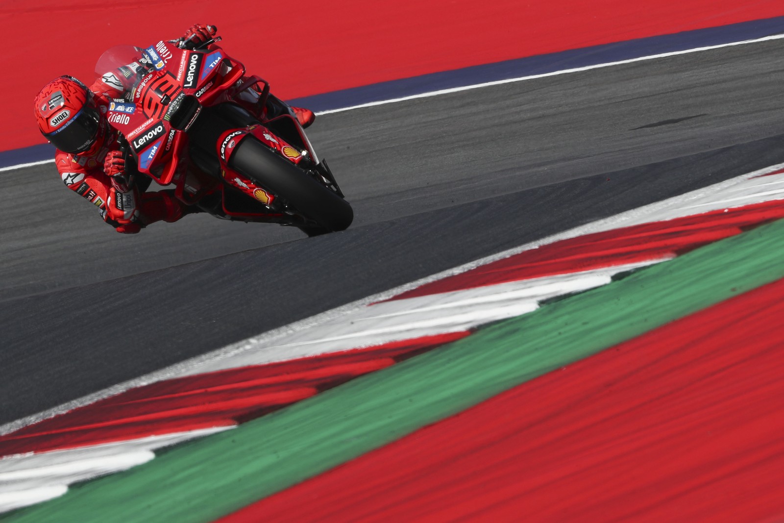 A motorcycle racer leans into a tight turn.