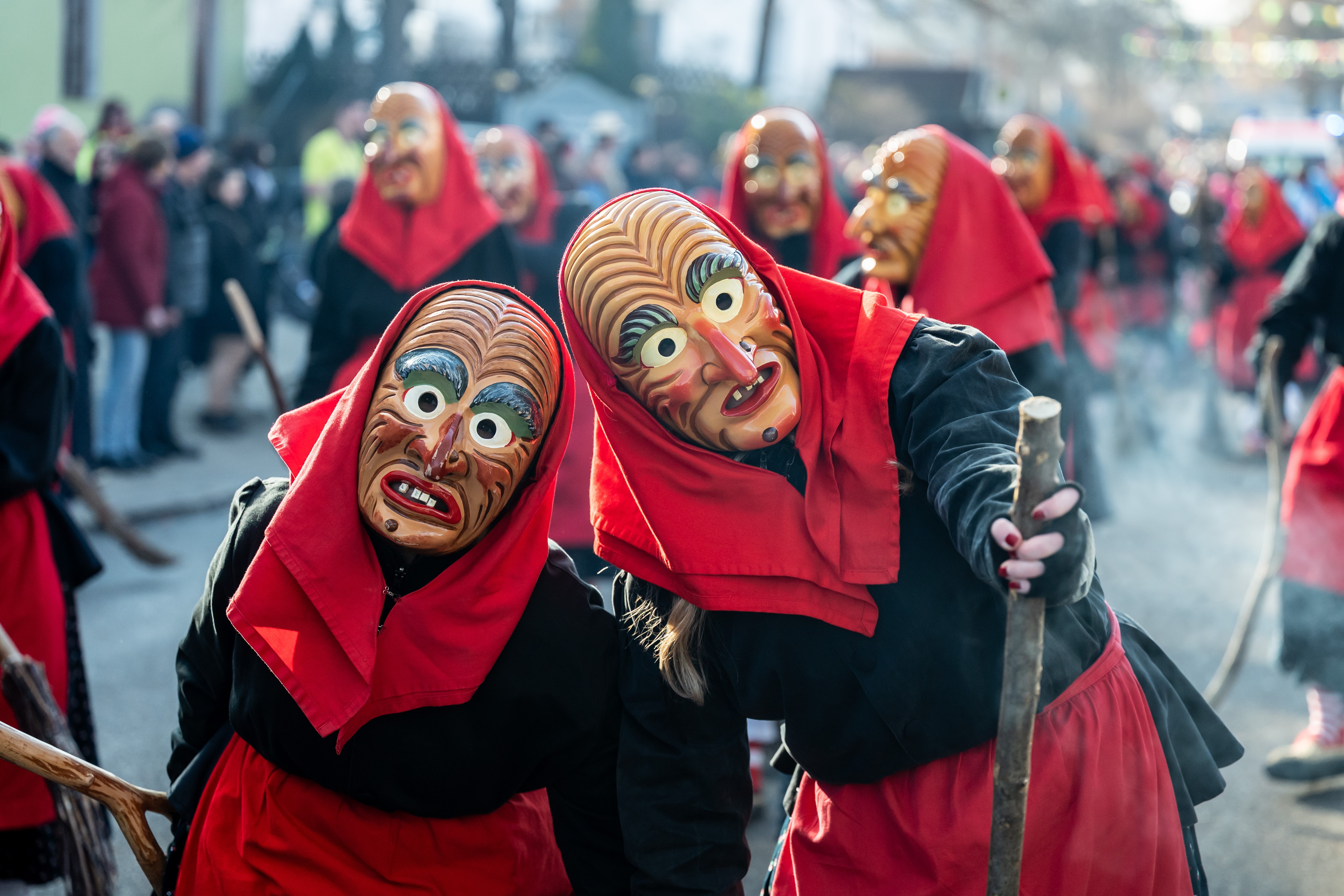 Participants parade, wearing masks, dressed as traditional the fool figures.