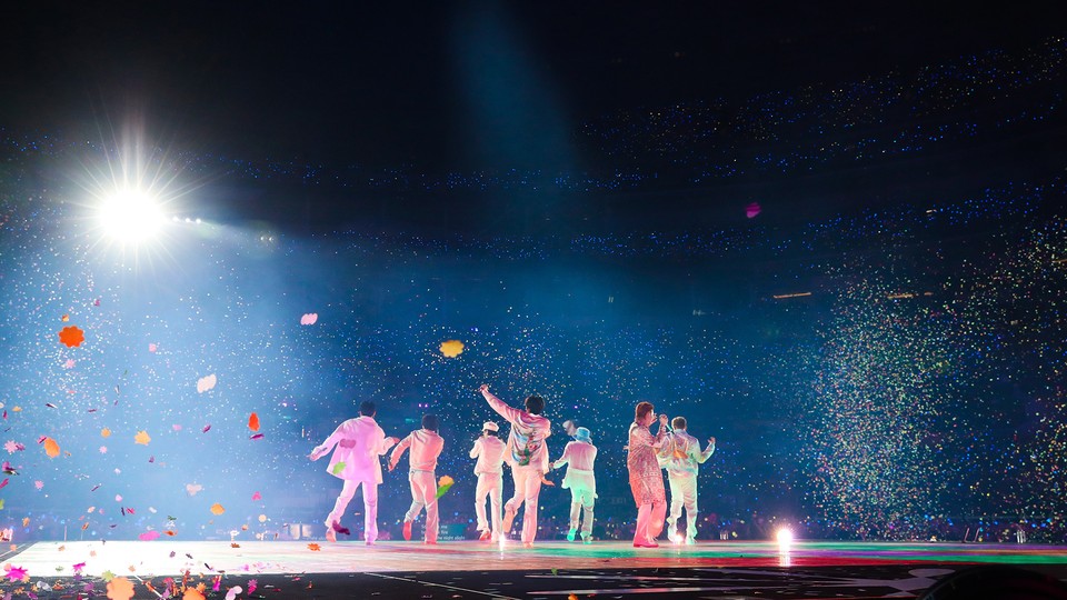 the seven members of BTS onstage surrounded by confetti
