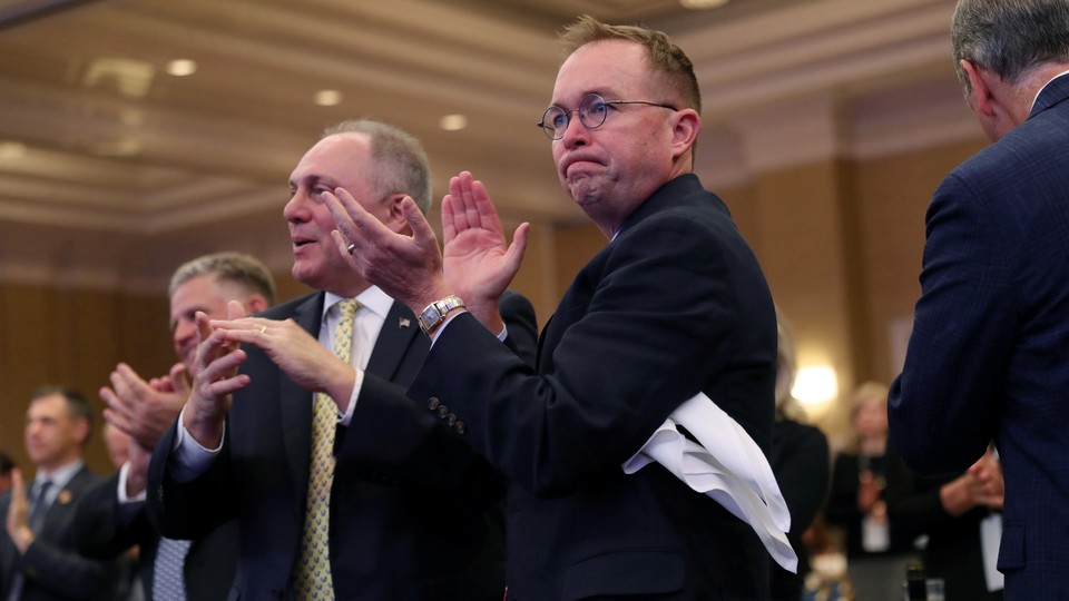 Acting White House Chief of Staff Mick Mulvaney applauds as U.S. President Donald Trump speaks at the 2019 House Republican Conference Member Retreat dinner in Baltimore, Maryland.