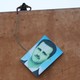 A rebel fighter stands atop a building and takes down a large picture of Assad after rebels captured the area in 2015.