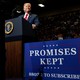 President Donald Trump stands at a lectern during a campaign rally.