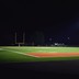 An empty football field at night.