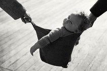 Photo of baby in basket between two adults