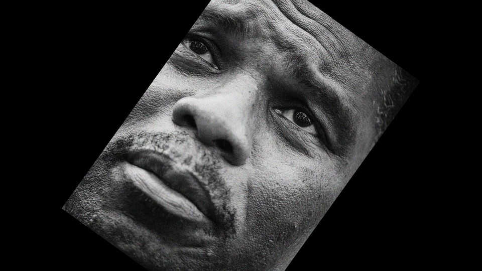 Black-and-white close-up photo of Herschel Walker tilted diagonally