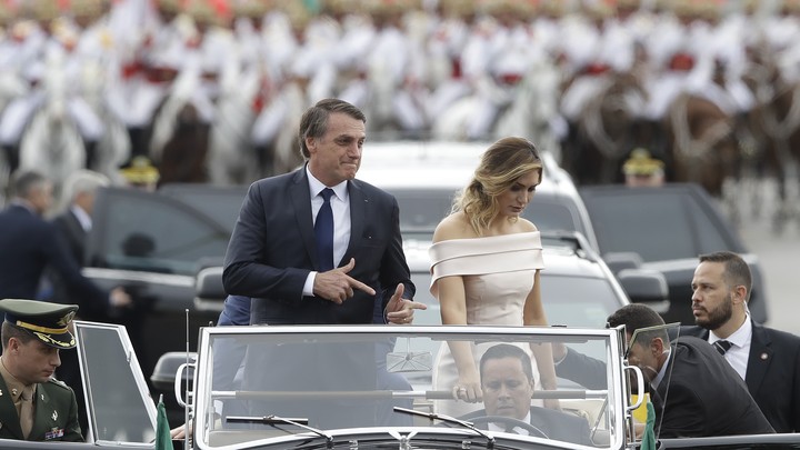 After his inauguration, Jair Bolsonaro makes the shape of a gun with his fingers—his trademark gesture.