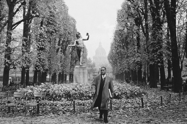 View of American author Richard Wright (1908 - 1960) as he walks in the Luxembourg Gardens, Paris, France, 1959