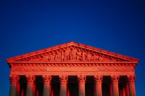 The Supreme Court in a reddish hue.