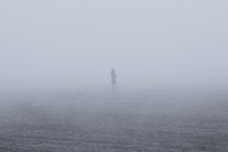 A woman walking in the mist