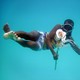 Hamissi Usi swims with an octopus on Pemba Island, Tanzania, in 2010.