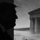 Black and white illustration of Trump in profile looming over the Supreme Court building.