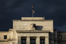The Federal Reserve building in front of a very dark and gloomy sky