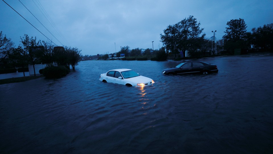 An abandoned car in rising flood waters in Wilmington, North Carolina, on Saturday