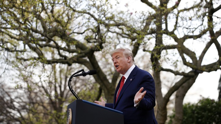 President Trump speaking at a podium outdoors