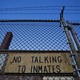 A jail with the sign "No Talking to Inmates"