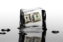 An illustration of a $100 bill inside a melting ice cube