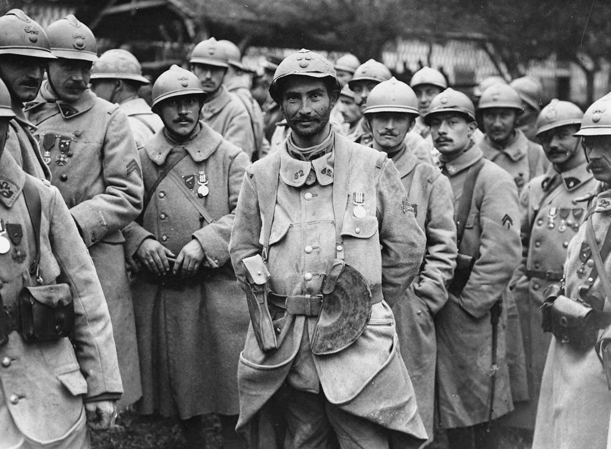 French soldiers stand in a relaxed group wearing medals. The medals appear to be the Military Medal, established on 25th March, 1916, for acts of bravery. They have probably been awarded for their part in the Battle of the Somme. The French helmets, with their very distinct crests, can be seen clearly.