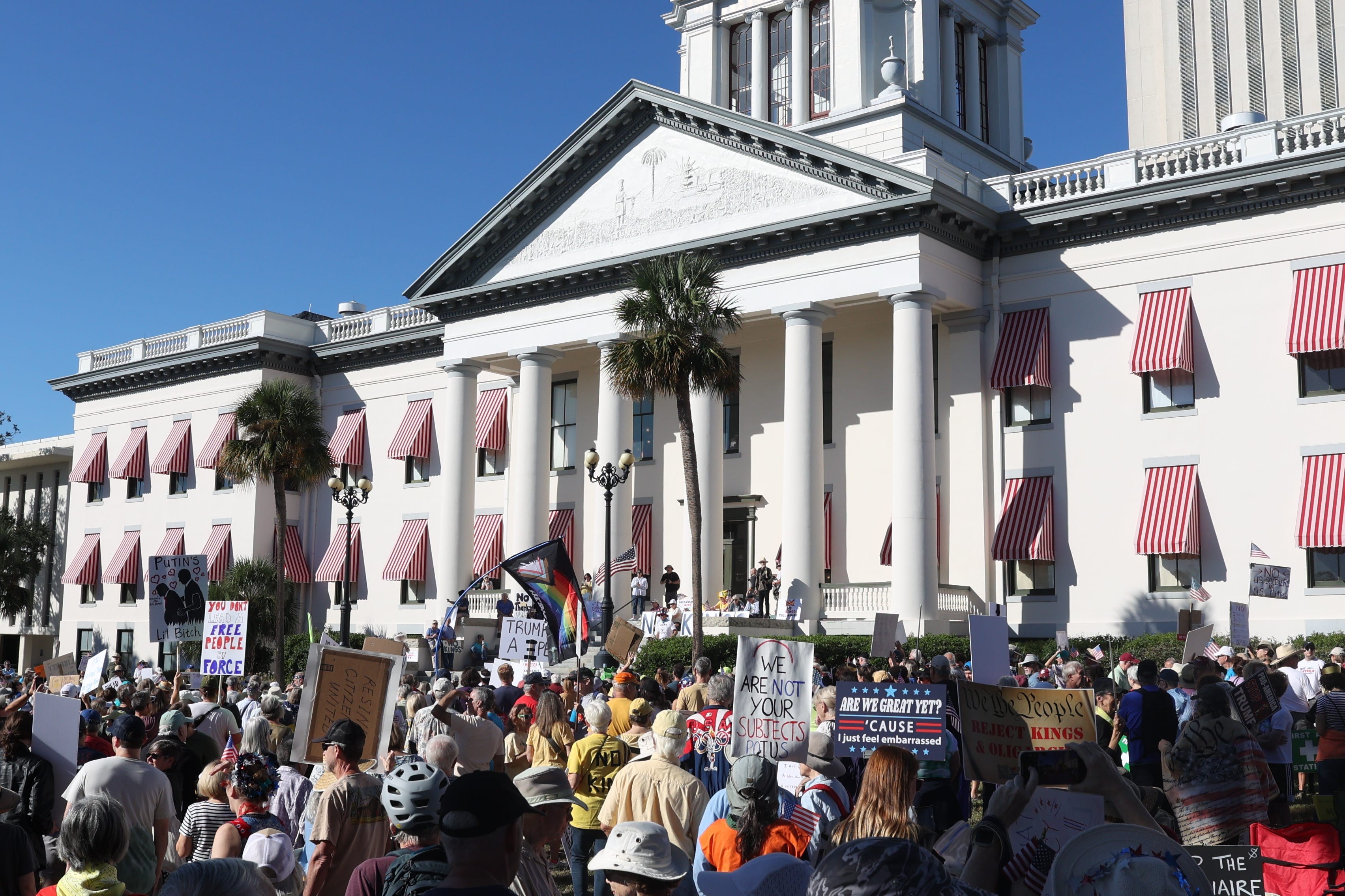 A crowd of protesters gathers in front of Florida's Old Capitol Building.