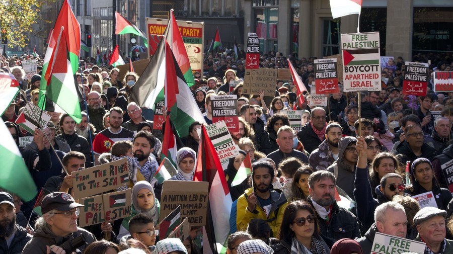 People carry Palestinian flags and placards during a demonstration in Glasgow in support of Palestine.
