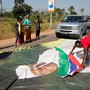 Supporters of President-elect Adama Barrow lay a Gambian flag across a poster of incumbent President Yahya Jammeh.