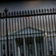 The White House is seen behind a gate.