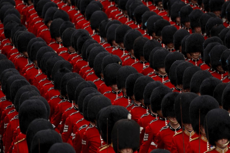 Many rows of British soldiers wearing dress uniforms and tall fuzzy hats