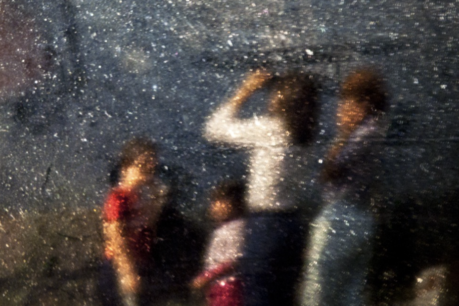 a manipulated image with scratches and dust shows a family star gazing