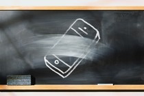 A chalkboard with a picture of a phone that's half erased