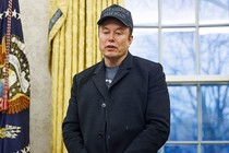 Elon Musk looks down while speaking from the Oval Office