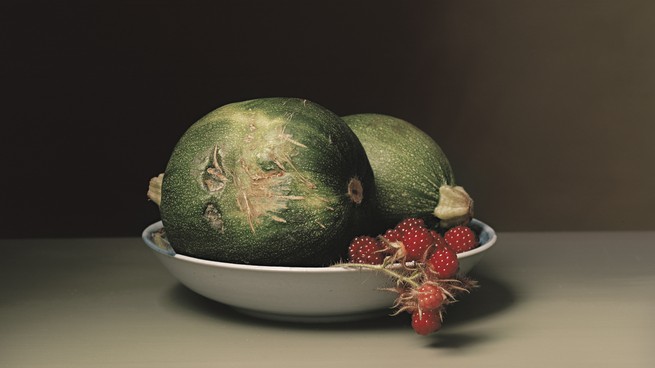 A bowl with squash and raspberries