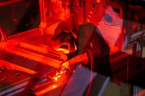 a welder works on a Tesla Model S in the Fremont, California, facility