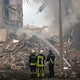 Firefighters and rescue workers at the scene of a Russian missile strike on Zaporizhzhya, Ukraine