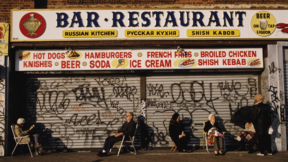 a closed restaurant with elderly patrons sitting in front of it on Brighton Beach in 1989