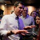 Pete Buttigieg speaks with a small cluster of people.