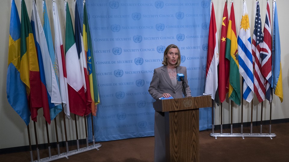 European Union foreign policy chief Federica Mogherini answers questions with flags of the Iran deal signatories behind her.