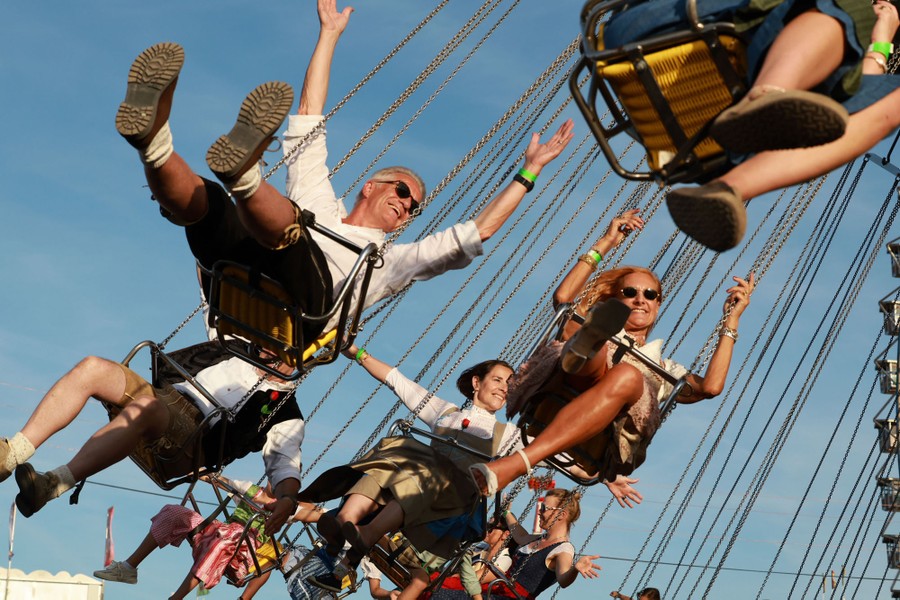 People ride in swings on a carnival ride.