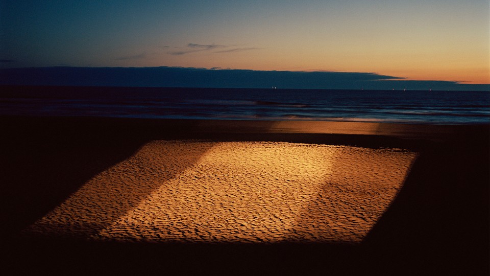 A square of light over sand on the sea