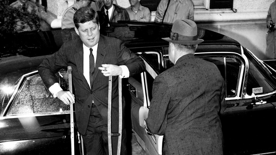 Kennedy's chronically bad back was only one of his enduring ailments. Here, he is heading to the presidential yacht in June 1961 to host the Japanese prime minister.