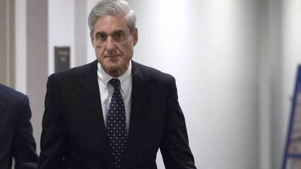 Special Counsel Robert Mueller walks through a hallway.