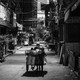 A woman pushes her food cart along an empty street in Bangkok