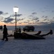 A man passes the giant bones of a bowhead whale in a field near Utqiaġvik, Alaska.