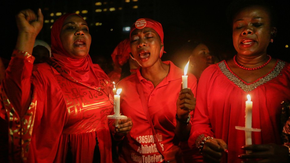 People hold candles during a vigil to mark one year since the Chibok girls' kidnap.