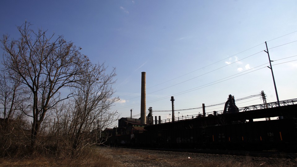 An abandoned-looking steel mill on a sunny day