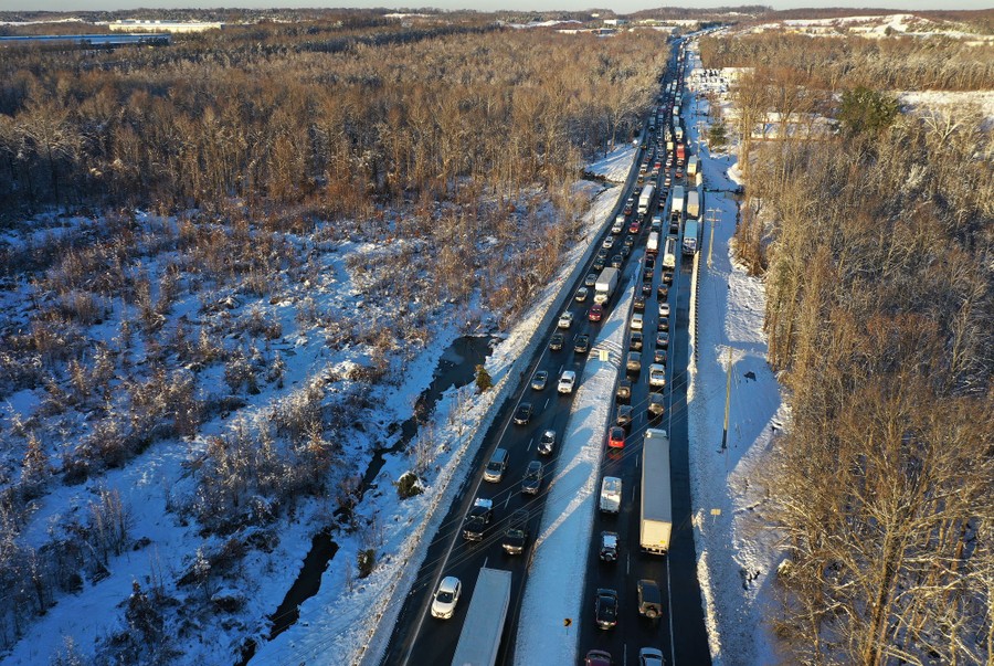 An aerial view of a highway completely jammed with cars and trucks