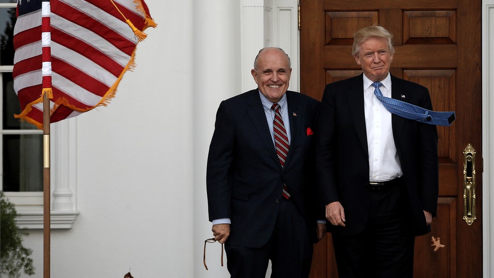 Donald Trump stands with Rudolph Giuliani before their meeting at Trump National Golf Club in Bedminster, New Jersey.