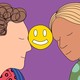 A man and a woman lean in smiling, holding a smiley face icon between their foreheads